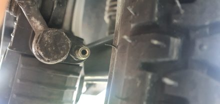 Loosen exposed screw only with negative pressure applied